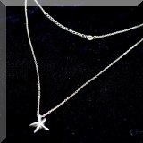 J10. Silver tone necklace with star pendant. 16” - $12